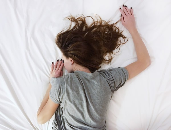 photo of woman sleeping face down