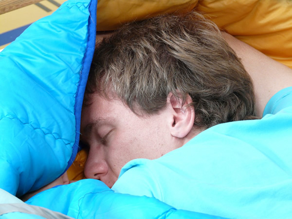 photo of a man sleeping on his stomach